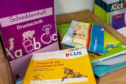 Classroom of a fourth grade, after school, the building is older but in good condition, textbooks,