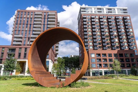 Walk-in steel sculpture on Maashaven Noordzijde Street, new high-rise residential buildings in the