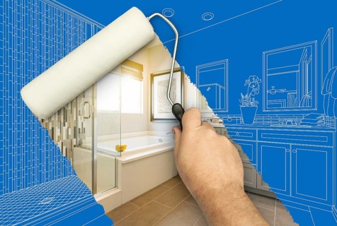 Before and after of man painting roller to reveal newly remodeled master bathroom under blueprint