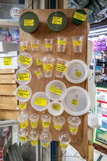 Disposable tableware for sale, display with prices at a stall, Mercado Central de San José, San