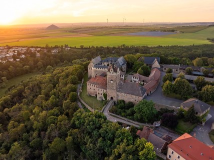 Historic castle surrounded by forests and fields in the evening light, Allstedt, Harz, Germany,