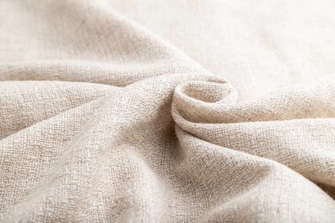 Fragment of white linen tissue. Side view, natural textile background and texture. wave concept,