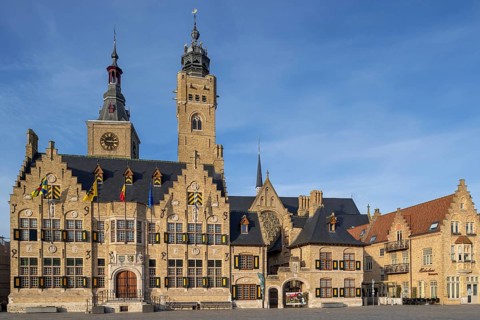 Market square showing town hall with belfy and St Nicholas Church tower, rebuilt after WWI in the
