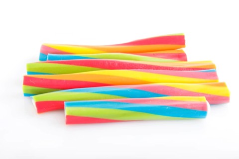 Rainbow chewing caramel sugar candies isolated on white background. top view