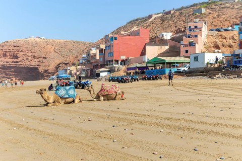 Sandy beach and buildings, Legzira, southern Morocco, north Africa