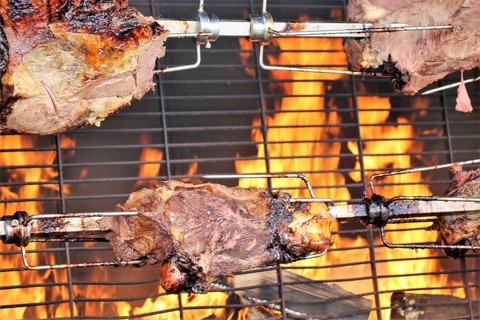 Suckling pig leg on the spit