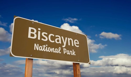 Biscayne national park (florida) road sign against blue sky and clouds