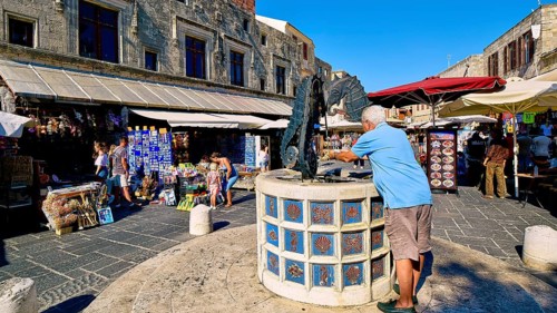 Martyrs Square, market square with seahorse fountain and shops in the background, sunny day with