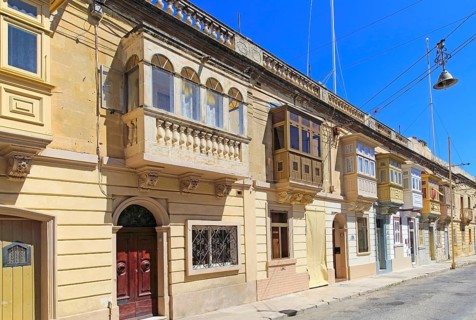 Balconies of houses historic street in Tarxien area, near Valletta, Malta, Europe