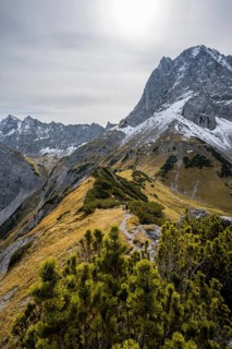 Mountaineers on a hiking trail on the ridge of Hahnkampl, mountain panorama with rocky steep peaks,