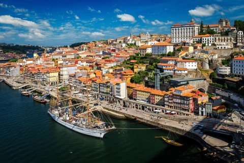 Aerial view of Porto city and Douro river with moored sailling ship from Dom Luis bridge I. Porto,