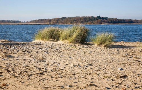 Benacre Broad lake is separated from the sea by the shingle beach bar of Benacre Ness, Suffolk,