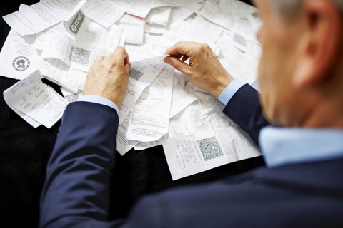 The subject of taxes. A man holds receipts in his hand in Berlin, 09/08/2024
