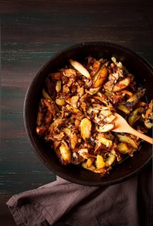 Fried chanterelles with mushrooms, in a clay pan, close-up, top view, selective focus