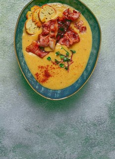 Pumpkin cream soup, curry, fried bacon, bruschetta chips, micro-greens, top view, no people