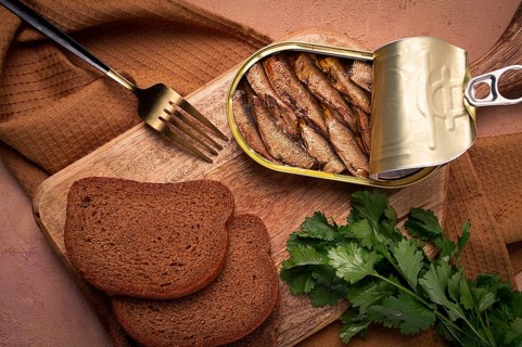Preserves, sprats with black bread, top view, no people