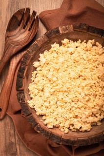 Cooked couscous, in a wooden bowl, top view, no people