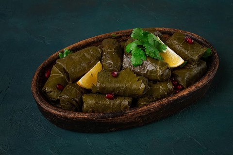 Dolma (Tolma) stuffed rolls, minced meat with rice, in grape leaves, top view, no people, close-up