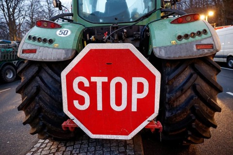 Large stop sign on a tractor. Thousands of farmers demonstrate with their tractors against the