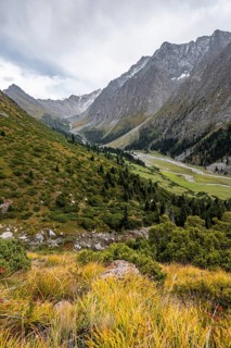 Green mountain valley with river and steep mountain peaks, Chong Kyzyl Suu Valley, Terskey Ala Too,