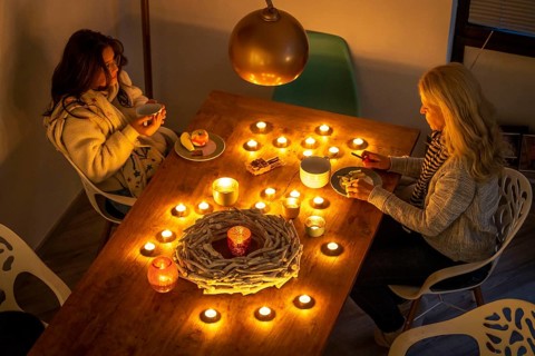 Symbolic image energy saving, cold winter, energy crisis, cold flat, mother and daughter dressed