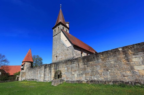 Small Easter fountain in front of the fortified church from the Middle Ages, fortified church,