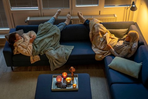 Symbolic image energy saving, cold winter, energy crisis, cold flat, mother and daughter lying on