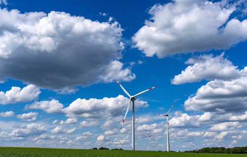 Wind farm, wind turbine, wind turbines from the manufacturer Enercon, blue sky with many white