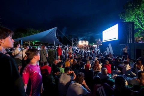 Visitors watch the football match at the Adidas fan zone at the Bundestag during the final match