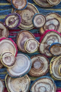 Handmade jewelery made from tree trunks and colored thread