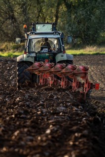 Farmer ploughing a field, tractor with plough, near Neuss, North Rhine-Westphalia, Germany, Europe