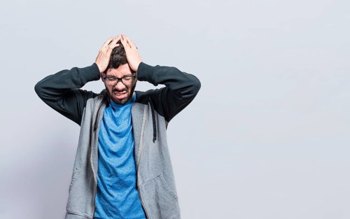 People rubbing his head isolated. Concept of a person with a headache isolated