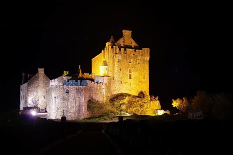 Impressive medieval castle illuminated at night, with festive atmosphere, Highlander, Braveheart,
