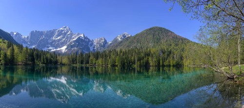 Mangart mountain range reflected in the lower Fusine Lake, Tarvisio, province of Udine, Italy,