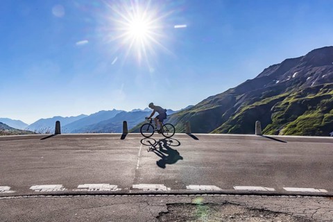 Furka Pass. A challenge for ambitious cyclists. Backlight with sun star. Realp, Canton Uri,