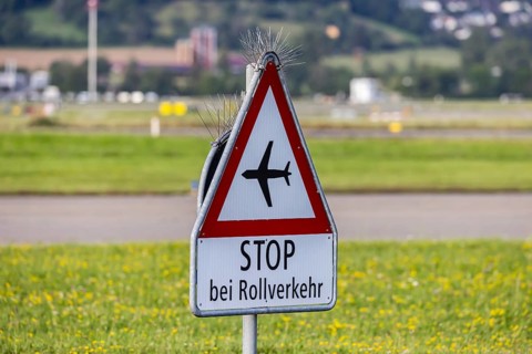 Traffic sign Stop at taxiing traffic, prohibition sign with aeroplane, Zurich Airport, Switzerland,