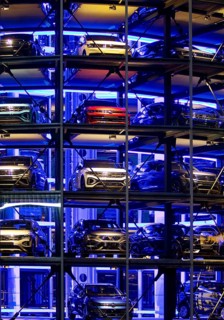 An illuminated car tower with new cars for delivery in the evening, detail, Autostadt, Volkswagen