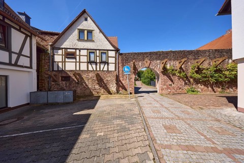 Historic town fortification with town gate under a cloudless blue sky at the Untere Pfarrgasse in