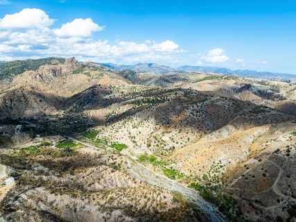Mountains and Olive groves around Ghost Town from a drone, Pentedattilo Village, Calabria, Italy,