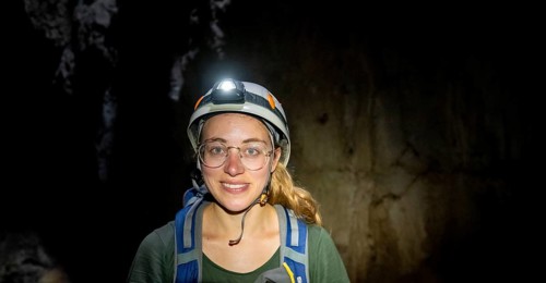 Tourist in a cave with helmet and headlamp, Barra Honda National Park, Costa Rica, Central America