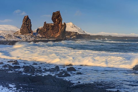 Rocks and surf on the coast, evening light, sun, snow, winter, Arnarstapi, Snaefellsnes,