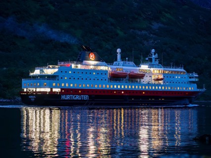 Hurtigruten cruise ship passes the Raftsund at night, the strait between islands Hinnøya and