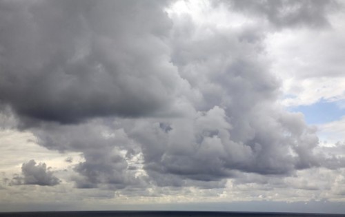 Heavy dark rain clouds pass over the land