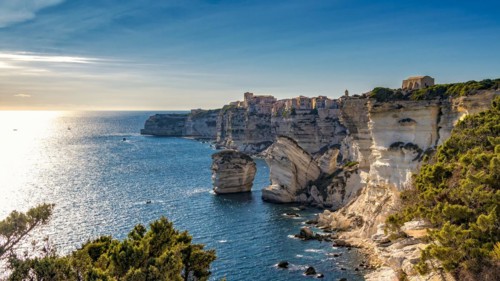Picturesque coastal town of Bonifacio with its limestone cliffs overlooking the sunlit sea in