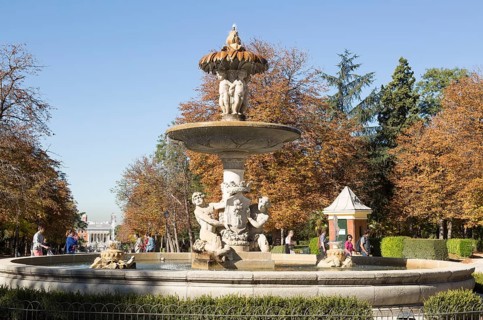 People walking by monument fountain in El Retiro park, Madrid, Spain, Europe