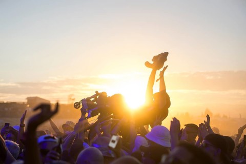 A wheelchair user crowdsurfing in front of sunset at the Highfield Festival on Friday, Störmthaler