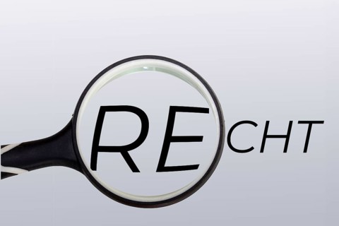 Symbolic image for law, jurisdiction and justice: a magnifying glass over the written word law