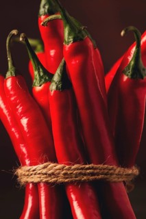 Bunch of red hot chili pepper, close-up, on a dark background, selective focus, no people, concept,