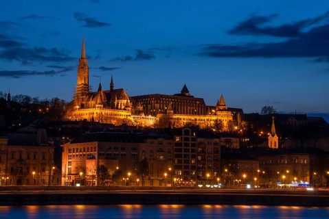 Royal Palace or the Buda Castle at sunset with lights illuminated at in danube river. Budapest