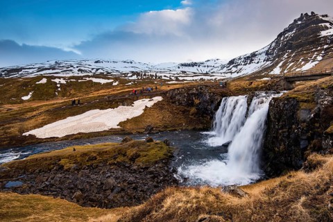The Kirkjufell mountain and the kirkjufellfoss waterfall at grundarfjordur at Snaefellsnes